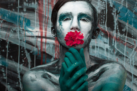 Image for article on dating someone with an invisible disability. Arty graphic of a man holding a red flower up to his mouth