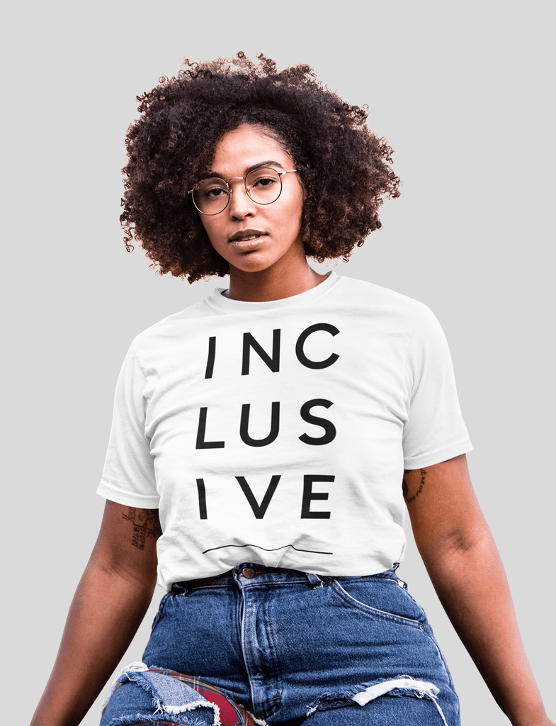 Inclusive clothing: woman is wearing a short-sleeve t-shirt with the word inclusive printed on it in black letters.