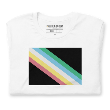 A folded white disability pride shirt. In the middle of the t-shirt is a dark grey-black background with five diagonal stripes in this order: red, yellow, white, blue, and green (when looking from the bottom up). The shirt is folded neatly with disability pride flag in the centre of the image.