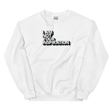 A white Not Your Inspiration sweatshirt. On the top third of the inspiration shirt is the phrase, "I am not your inspiration," printed over four lines in white upper case letters with a black retro shadow.