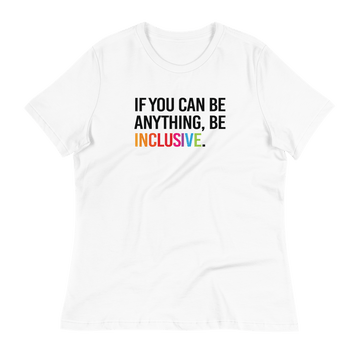 This is a photo of a white relaxed-cut Be Inclusive Tee Be against a plain background. On the front of the t-shirt, the phrase, 'If you can be anything, be inclusive,' is printed in black capital letters.   The word "Inclusive" is in rainbow colors.