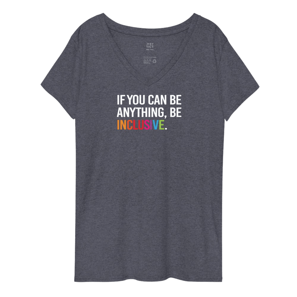 This is a photo of a heathered navy Eco-Friendly Be Inclusive V-neck tee. In the top third of the tee, in white upper case letters, is the phrase, 'If you can be anything, be inclusive,' The words, be inclusive, are in the colors of the rainbow.