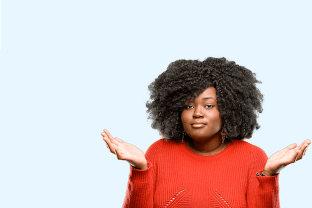 Photo for an article on coming out as bipolar. A black woman is shrugging her shoulders palms facing upwards, saying to herself: 