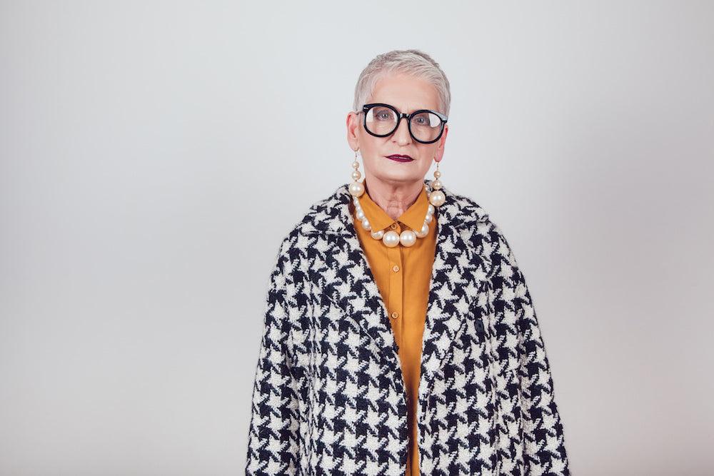Photo for article on caring for a parent with Alzheimer's. Stylish and elegant old person wearing a checkered coat and funky eye glasses.