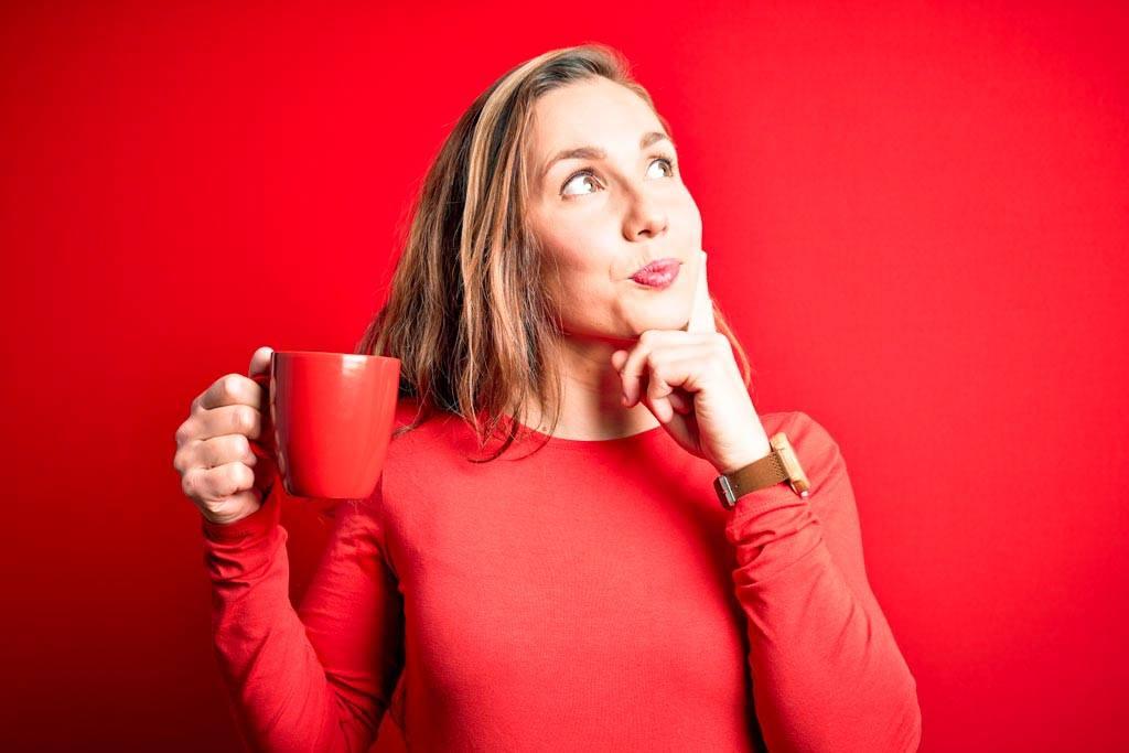 A person who long blonde hair is holding a red cup in their hand and thinking to themselves, 