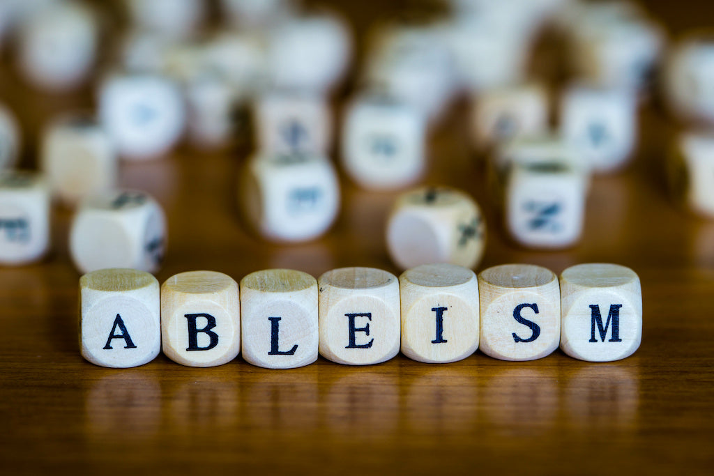 Ableist language: photo of the word ableism spelt using wooden square blocks