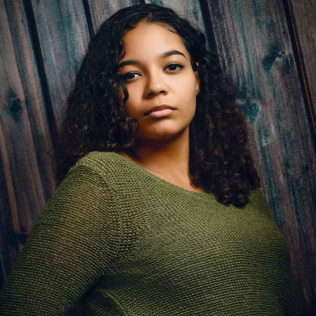 Epilepsy at school: a teenager with a serious expression is looking directly at the camera.