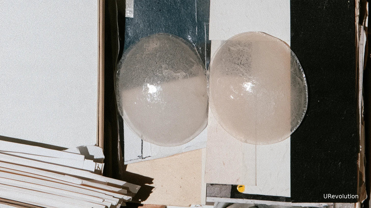 Conceptual collage of two translucent forms in an open cabinet, with stacked blank papers beside them.
