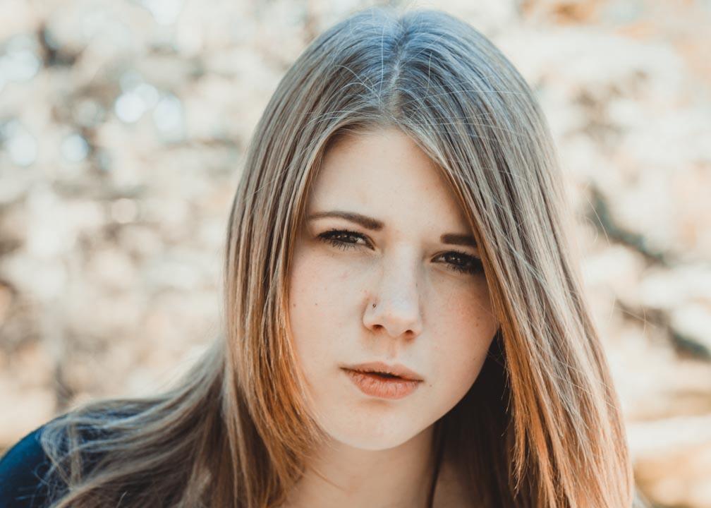 A photo of a teenage woman reflecting on the struggle of passing as able-bodied while growing up with cerebral palsy.