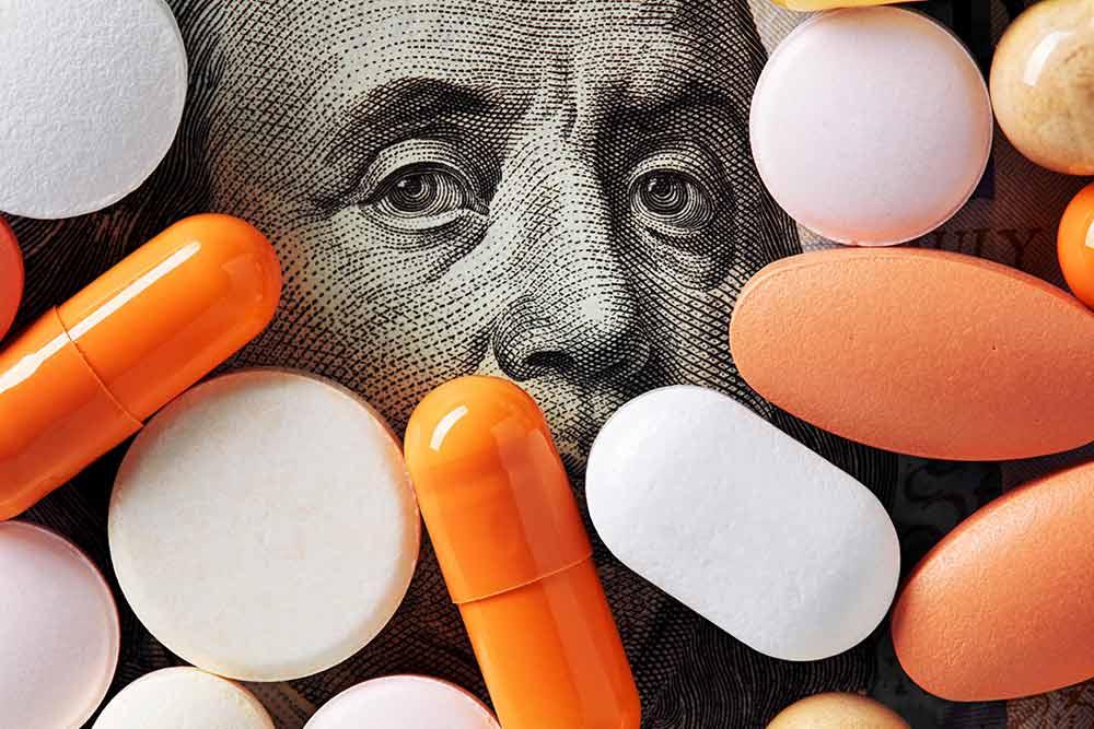 Photo for article: what are medical biases? Photo of brightly colored pills on top of Benjamin Franklin's face on a US one hundred dollar bill.