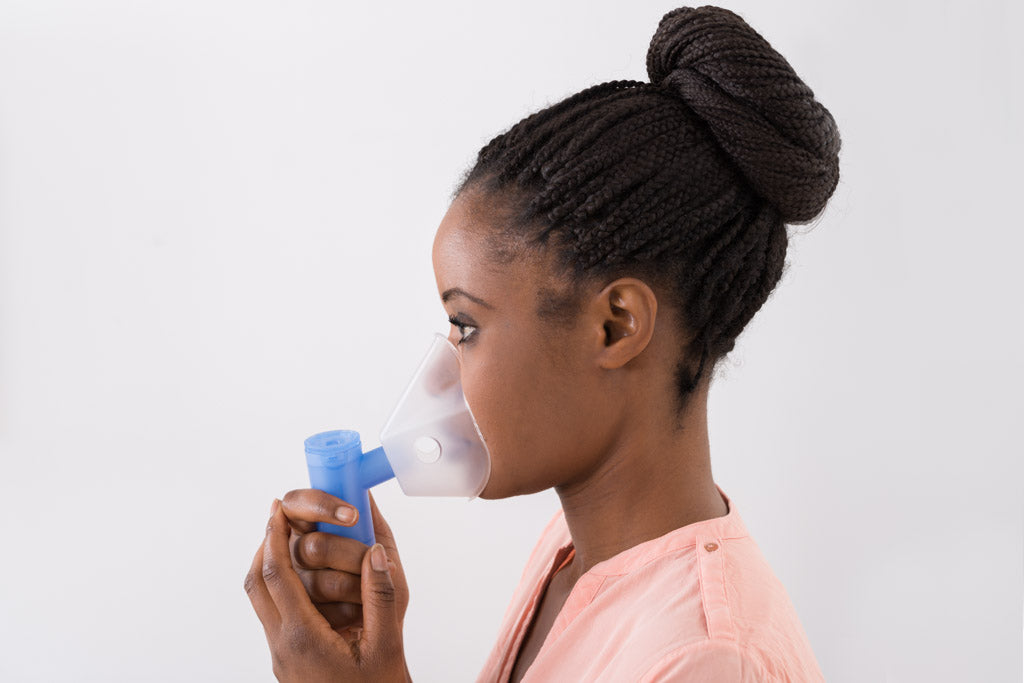 A close-up photo of a young African Woman using an oxygen mask. Image for an article: 'How my disability prepared me for Covid-19'