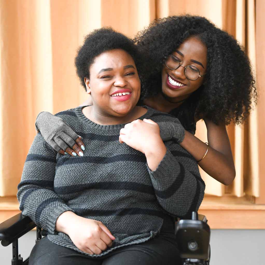 Disabled friends having fun. Close-up of two Black.