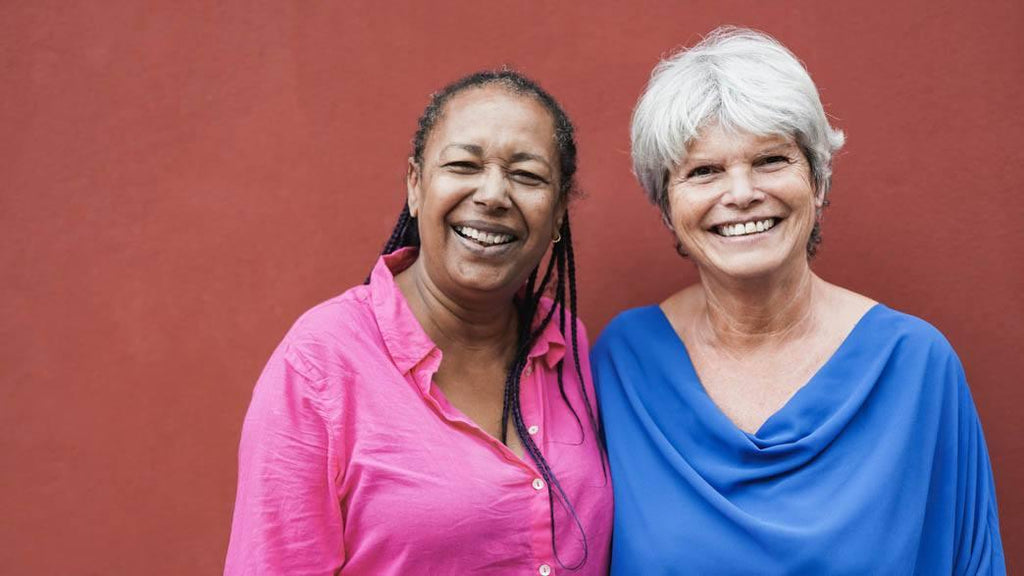  Image for article: when friends don't understand chronic illness. A bright color photo of two older multiracial women looking and smiling on camera. 
