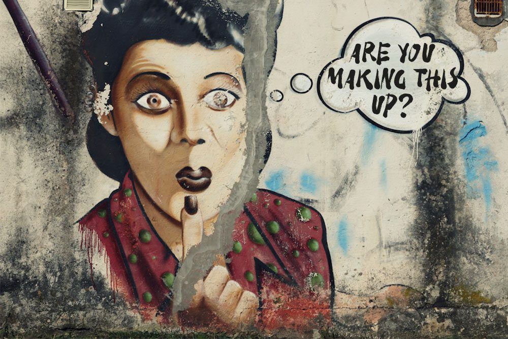 How to ask someone about their health? A faded graffiti portrait on a cement wall. Portrait of a person with a block bob haircut and deep purple lipstick. Their index finger with deep purple nail polish is on their chin.