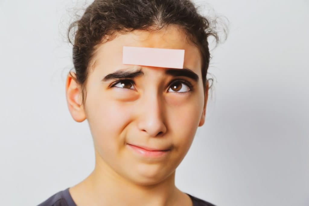Photo about the power of labels : A young girl with a memo label on her forehead. Image for an article exploring the power of language and labels and the stigma of labels.