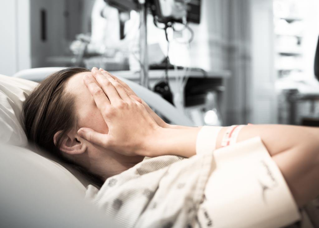 Why is the doctor ignoring my symptoms? A young woman patient is lying in a hospital bed feeling frustrated about her doctor gaslighting her. Image for the article: 