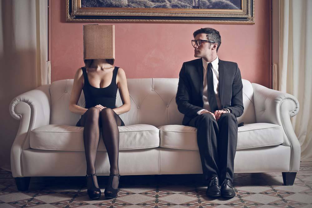 \What is it like to have a mental illness? A man and woman sit on a fancy white two-seater sofa.