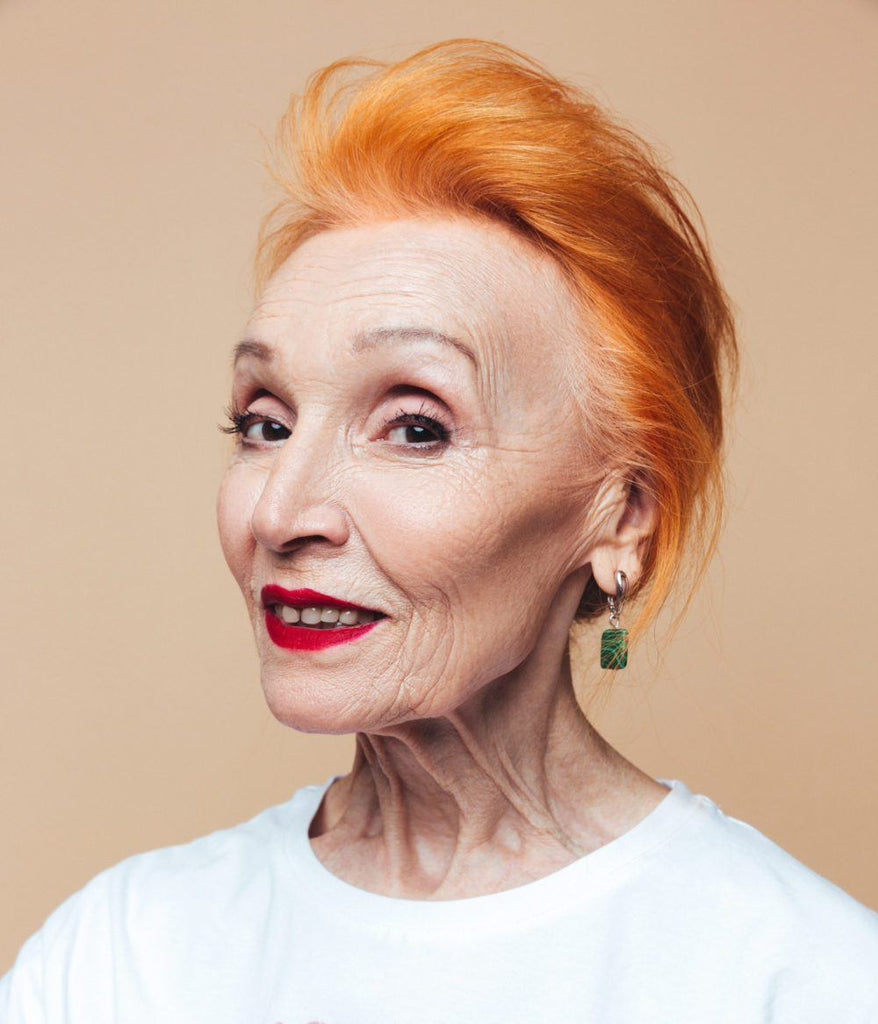 Photo of older woman in red hair, grinning at the camera. Image for an article, nurses can get breast cancer too.