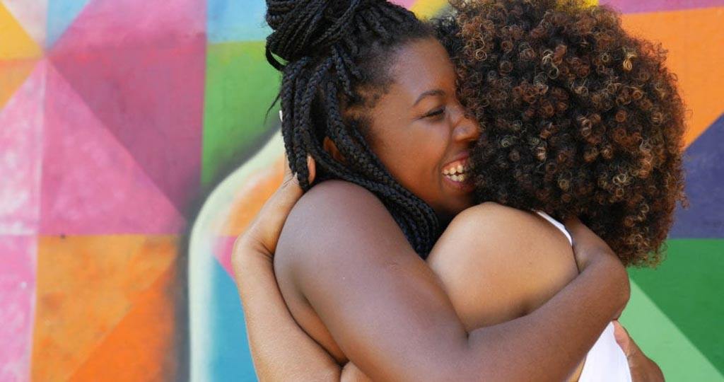 Image for article: what cancer taught me about life. Two women embrace each other deeply. 