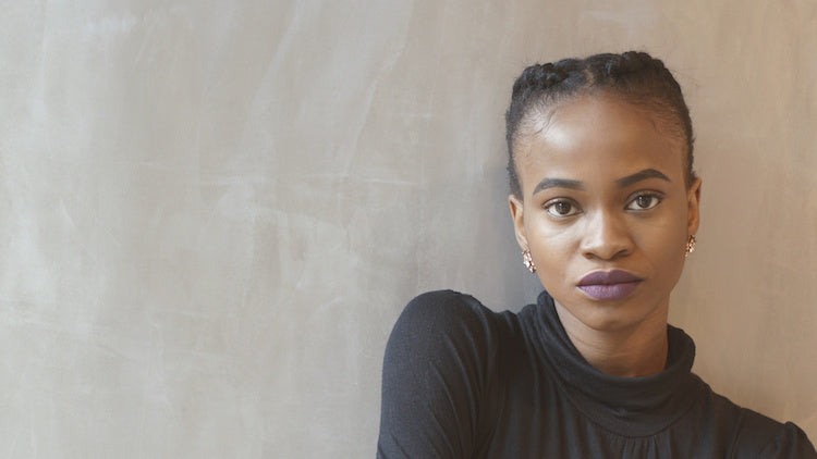 Image for article: Does language affect perception of mental illness? A young woman looks head on to camera with an intense, serious gaze. She looks a bit tough like you shouldn't mess with her. 