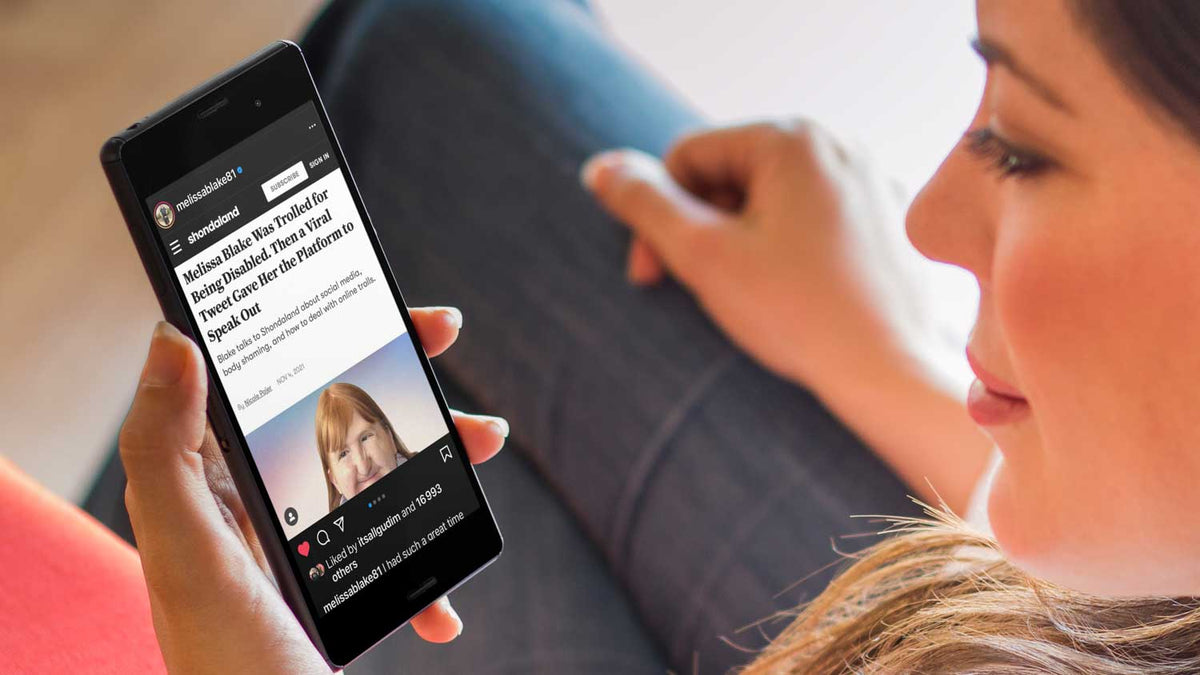 A person holds a phone displaying an Instagram post by Melissa Blake.
