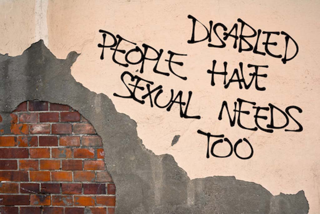 Cerebral palsy and intimacy: a true story about sex with cerebral palsy.' Graffiti spray painted on a wall with exposed bricks. The words say 