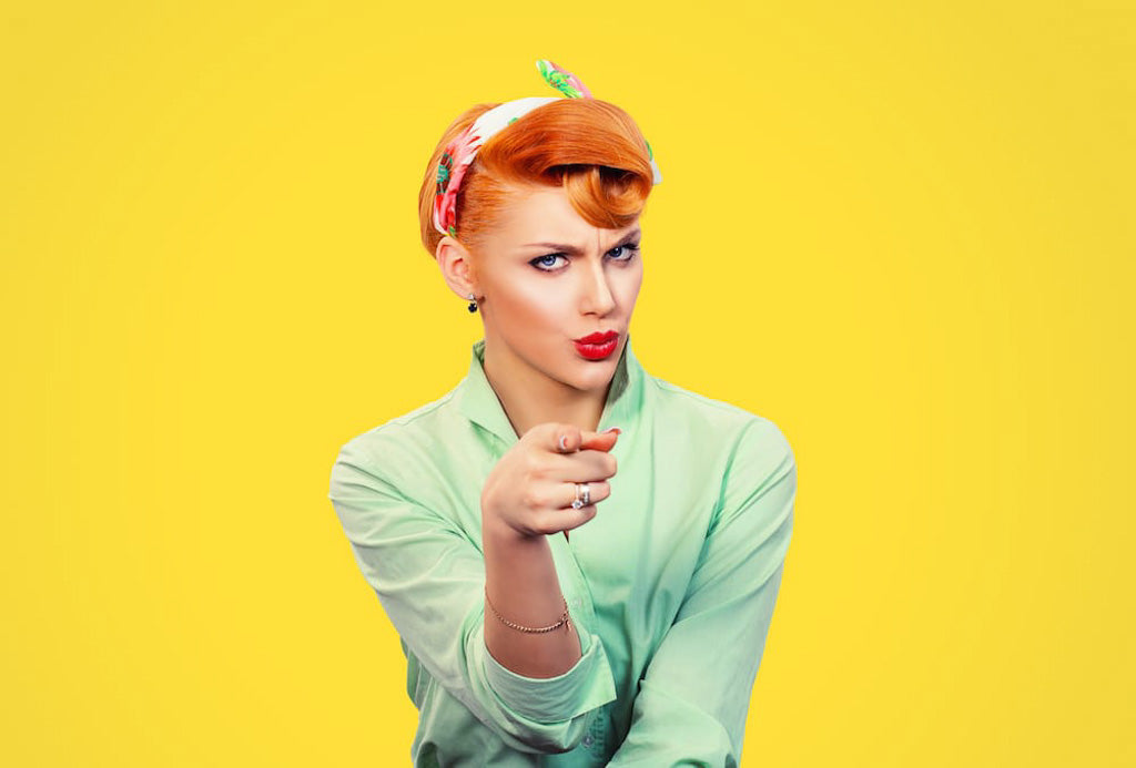 It's you! Portrait angry annoyed pin up retro style (circa 1950's) woman getting mad pointing finger at you camera showing hand gesture this is you,asking the question: do anti-stigma campaigns work?