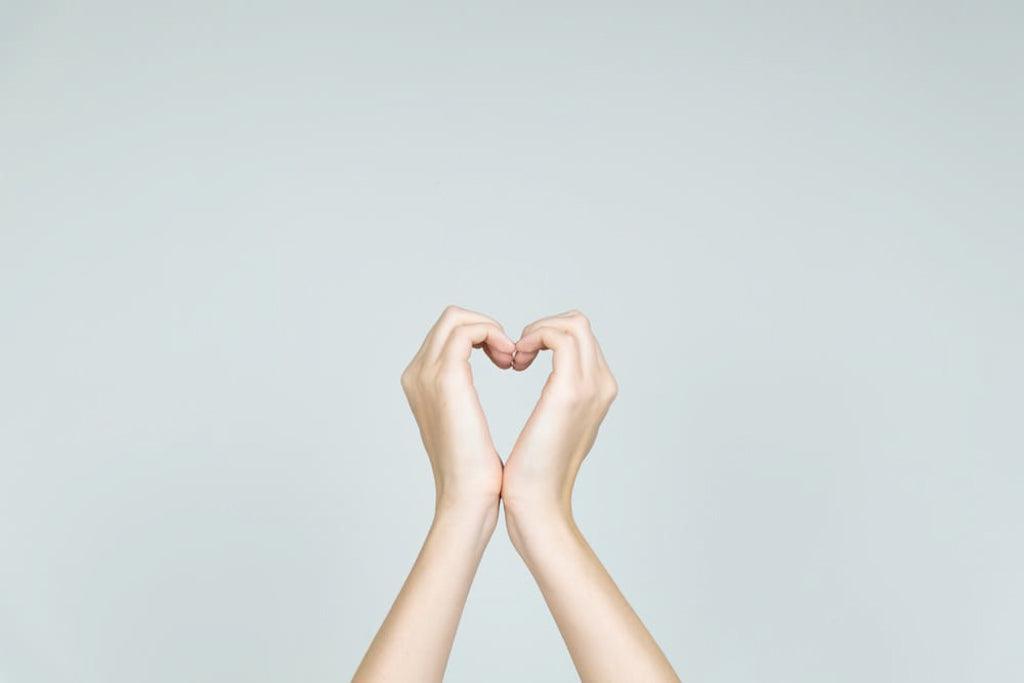Image for man article: is palliative care just for the dying? Image conveys a concept of love and kindness concept: hands forming the shape of heart. Heart formed of female hands in neutral background.