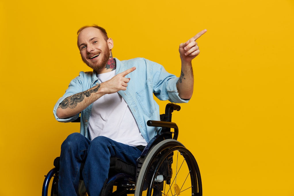 A man in a wheelchair laughing about kids' curiosity about wheelchairs