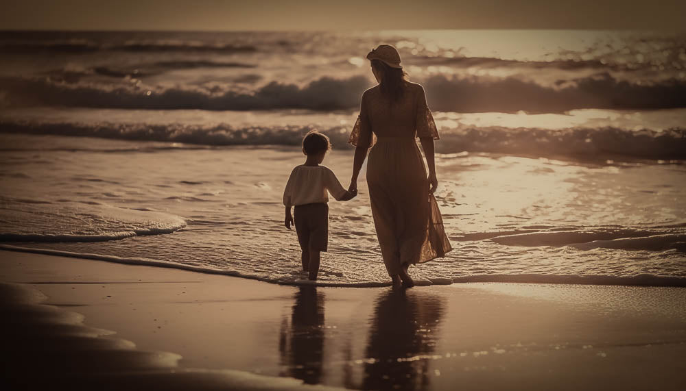 losing my mom to cancer: a old sepia photo of a mother and child wading in the shallow waves on a beach at dusk.