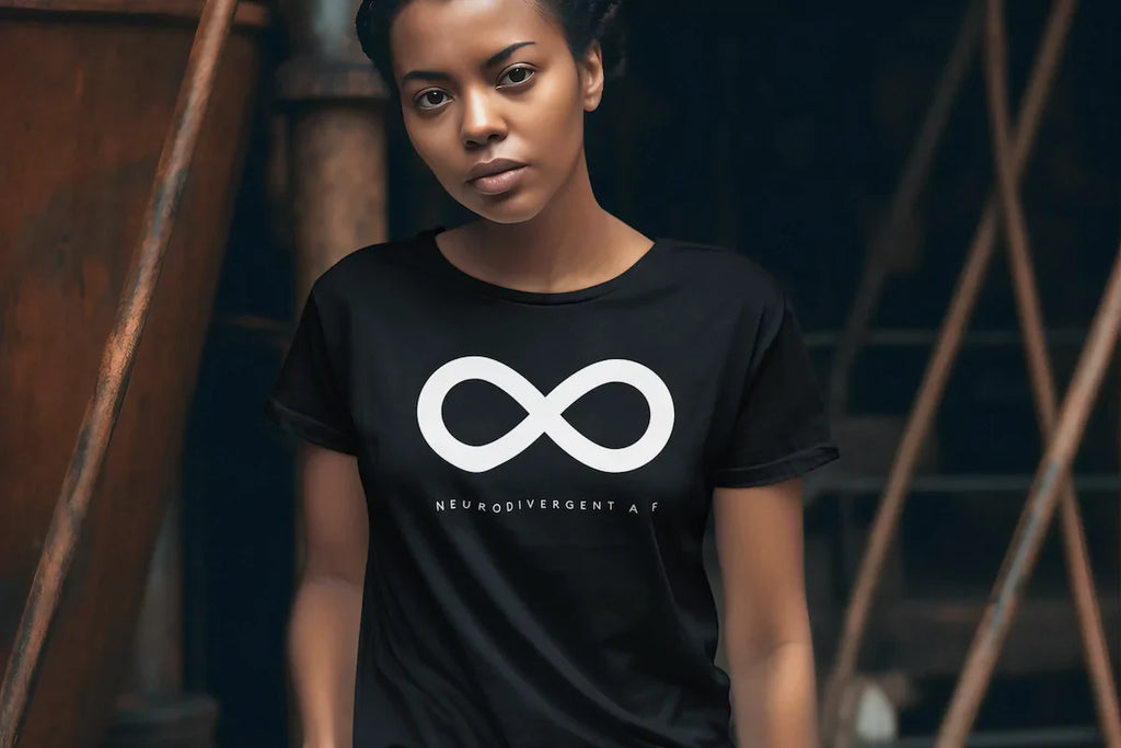 Black woman wearing a URevolution 'Neurodivergent AF' t-shirt, proudly embracing her autistic identity and neurodiversity awareness.