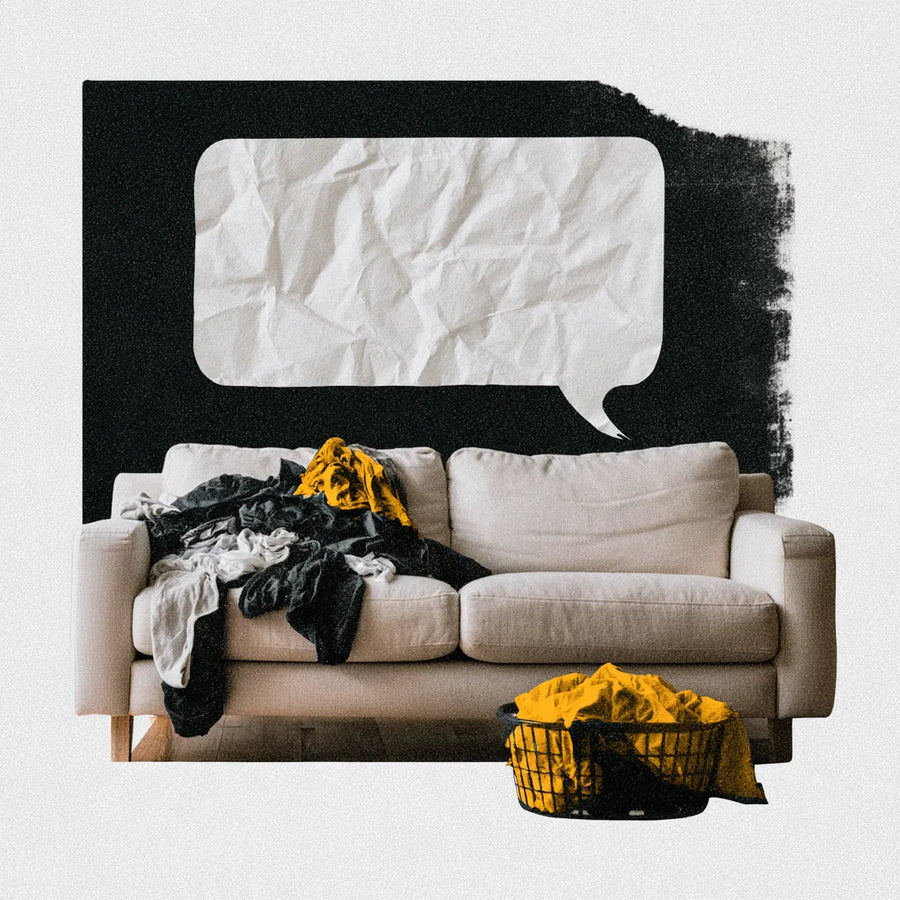 A crumpled blank speech bubble above a sofa piled with laundry, with a basket of yellow clothes in front.