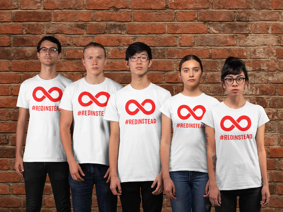 Group of people wearing Red Instead shirts standing in front of a brick wall