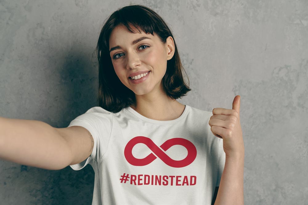 Autism acceptance not awareness:  photo of a person wearing a #RedInstead t-shirt. #RedInstead being one of the phrases promoted during Autism Acceptance Month.