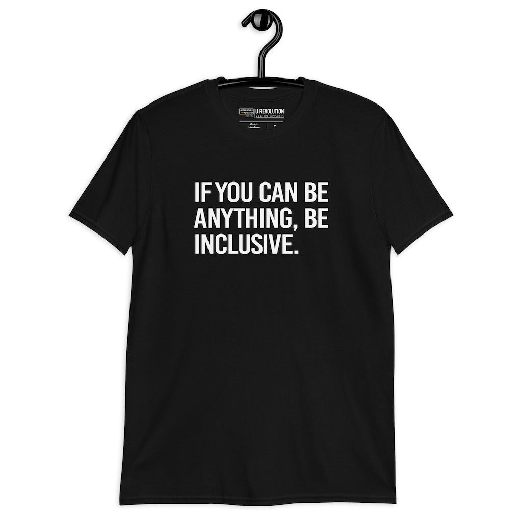 This is the photo of a black Be Inclusive Basic Tee. On the front of the t-shirt, the phrase, 'If you can be anything, be inclusive,' is printed in white capital letters. The t-shirt is on a hanger.
