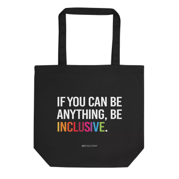 Picture of URevolution's eco-friendly organic Be Inclusive tote bag featuring our original phrase printed in white upper case letters: "If you can be anything, Be Inclusive." The word inclusive is in the colors of the rainbow. The phrase takes up three-quarters of the tote bag.  At the bottom of the bag the word URevolution is printed in small upper case letters.