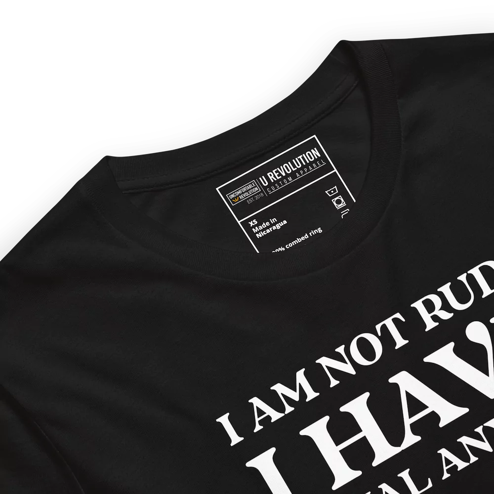 Close up of the color of a black t-shirt with white text that reads "I Am Not Rude, I Have Social Anxiety." A statement tee for social anxiety awareness