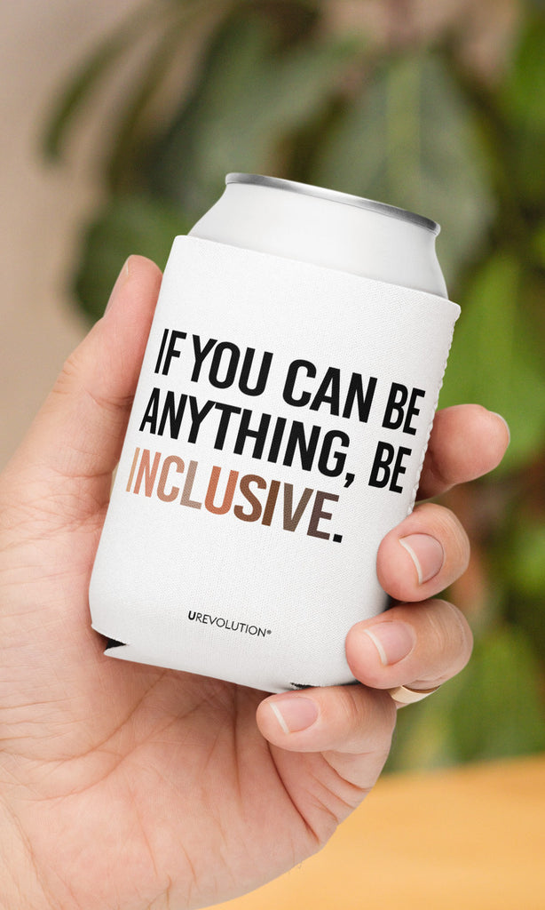 A 12 oz Inclusive Diversity Koozie held in the palm of a person's hand. On the front of the neoprene diversity koozie, in upper-case letters printed on a white koozie, is the phrase, "If you can be anything, be inclusive." The text is all black except for the word "Inclusive," which is in different skin colors, with the lightest color on the left and the darkest on the right promoting racial equality.