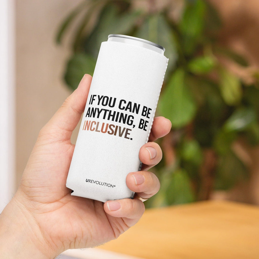 A slim 12 oz Inclusive Diversity Koozie. On the front of the neoprene diversity koozie, in upper-case letters printed on a white koozie, is the phrase, "If you can be anything, be inclusive." The text is all black except for the word "Inclusive," which is in different skin colors, with the lightest color on the left and the darkest on the right promoting racial equality. The stubby cooler is held int he palm of a hand.