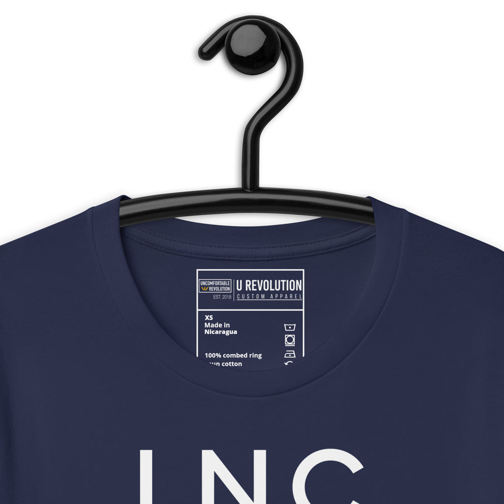 Close-up of the navy INCLUSIVE Statement Tee typography – bold and minimalist lettering arranged in three-line format, representing diversity and inclusion.