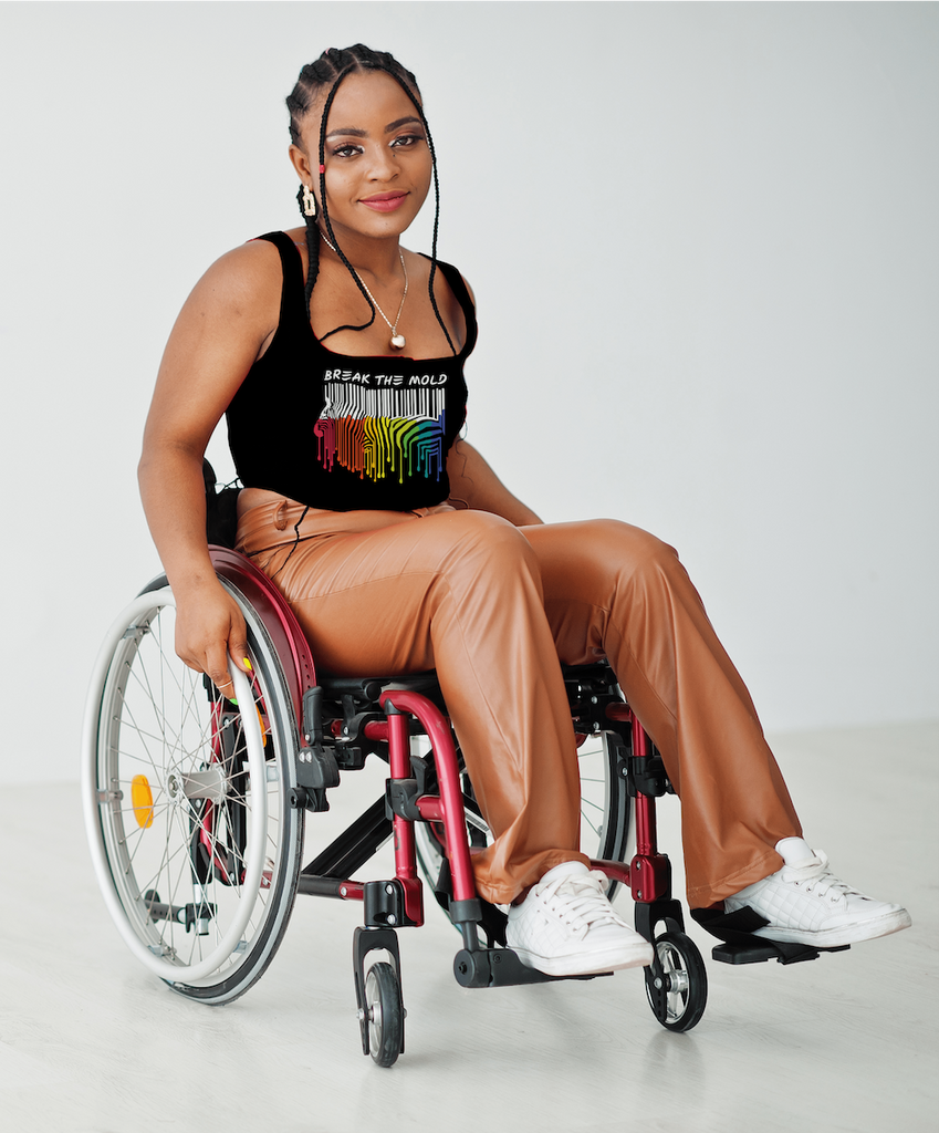 A person in a wheelchair is wearing a black singlet with a Break The Mold design printed on it.
