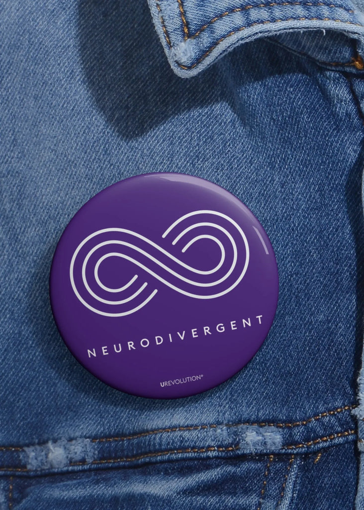 Purple Neurodivergent Pin-Back Button worn on a blue denim jacket, representing creativity and uniqueness