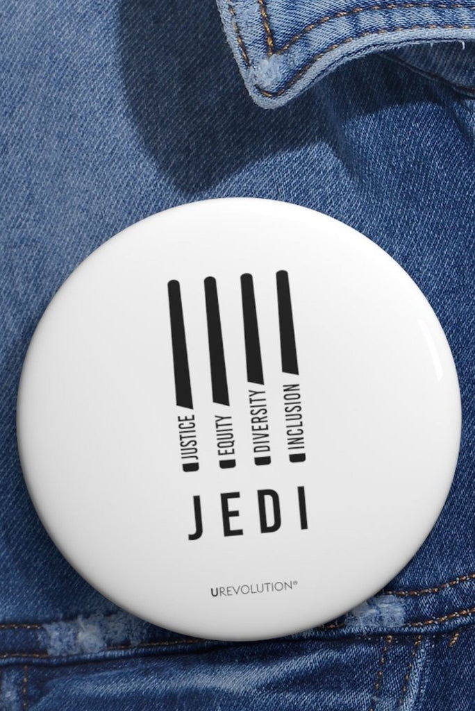 White JEDI pin reading ‘Justice, Equity, Diversity, Inclusion’ for social justice displayed on a denim jacket.