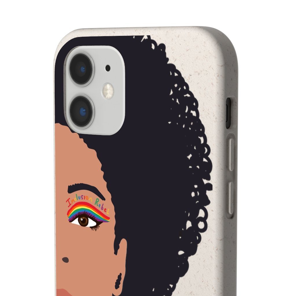 Close up photo of an iPhone 12 Inclusion Rebel Afro Phone Case. Printed on the back of the biodegradable phone case is an illustration of the right-hand half of a black person's face. They have a full afro and have a colorful eyeliner design above their right eye. The design includes a series of lines drawn in the colors of the LGTB flag with the words, Inclusion Rebel, outlined in a handwriting style above the lines.