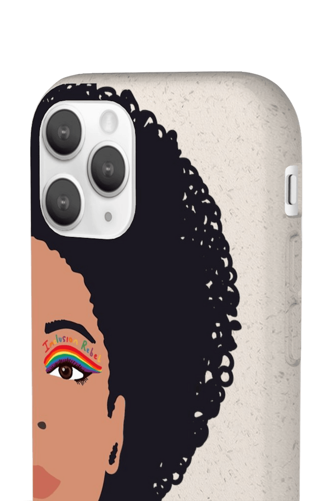Close up of a iPhone 11 Pro Inclusion Rebel Afro Phone Case. Printed on the back of the biodegradable phone case is an illustration of the right-hand half of a black person's face. They have a full afro and have a colorful eyeliner design above their right eye. The design includes a series of lines drawn in the colors of the LGTB flag with the words, Inclusion Rebel, outlined in a handwriting style above the lines.