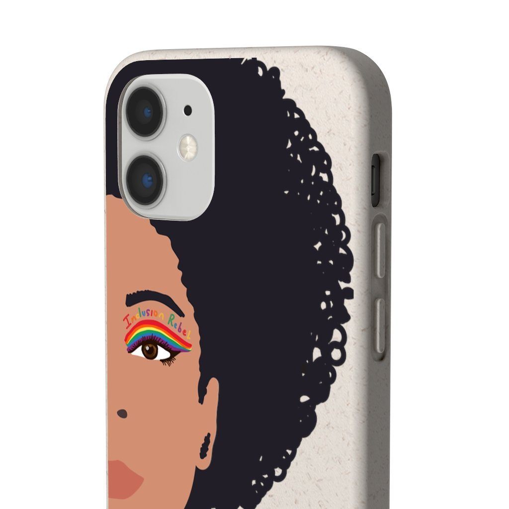 Close up photo of a iPhone 12 mini Inclusion Rebel Afro Phone Case. Printed on the back of the biodegradable phone case is an illustration of the right-hand half of a black person's face. They have a full afro and have a colorful eyeliner design above their right eye. The design includes a series of lines drawn in the colors of the LGTB flag with the words, Inclusion Rebel, outlined in a handwriting style above the lines.