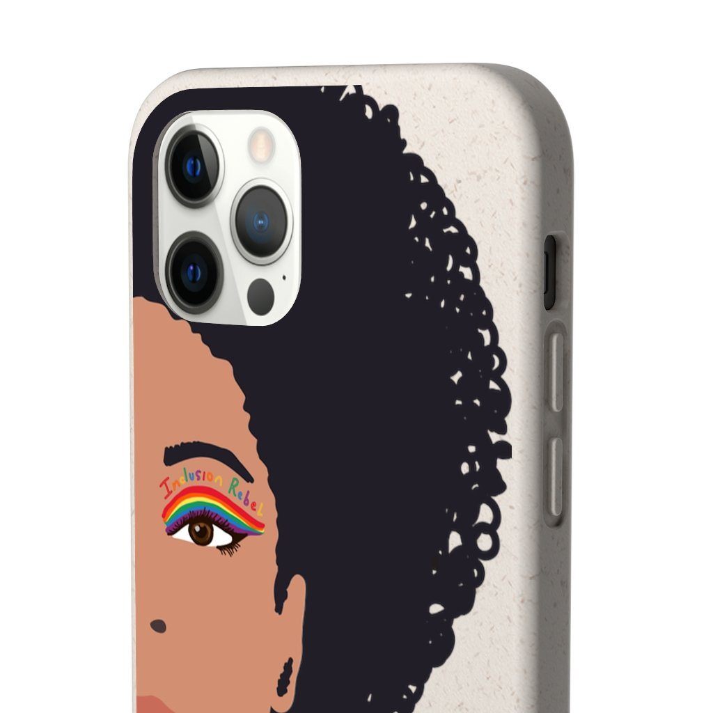 Close up of a iPhone 12 Pro Inclusion Rebel Afro Phone Case. Printed on the back of the biodegradable phone case is an illustration of the right-hand half of a black person's face. They have a full afro and have a colorful eyeliner design above their right eye. The design includes a series of lines drawn in the colors of the LGTB flag with the words, Inclusion Rebel, outlined in a handwriting style above the lines.