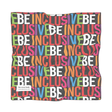 Front view of scarf that has the words BE INCLUSIVE in bold rainbow colored caps repeated to form a print. There is a small white tag in the bottom left corner that says For every body in very small black text and www.urevolution.com