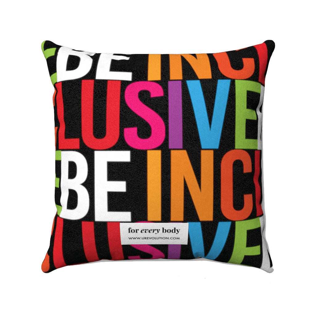 Be Inclusive Faux Suede Pillow-Home Decor-14" x 14"-Uncomfortable Revolution-The words BE INCLUSIVE are printed in huge caps. Be is in white, and Inclusive is in rainbow colors. The words repeat to form an all-over print. A small white tag with "For every body www.urevolution.com" printed in black text is at the bottom center of the back side of the pillow.  Edit alt text