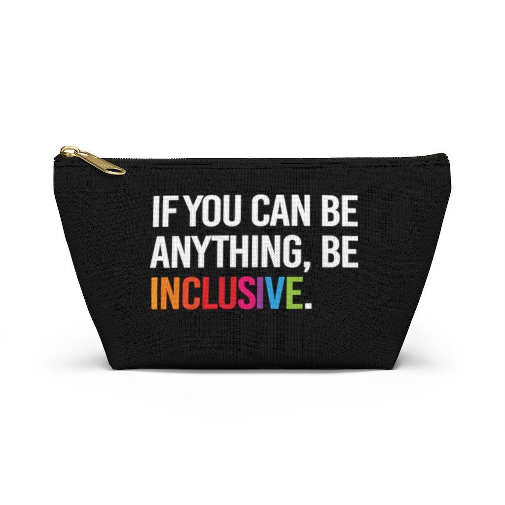 The Be Inclusive pouch is black and has text printed in large all caps, taking up most of the front surface area: "IF YOU CAN BE ANYTHING, BE INCLUSIVE." All text is in white, except "Inclusive" which is in rainbow colors. The pouch has a black zip and gold closure.